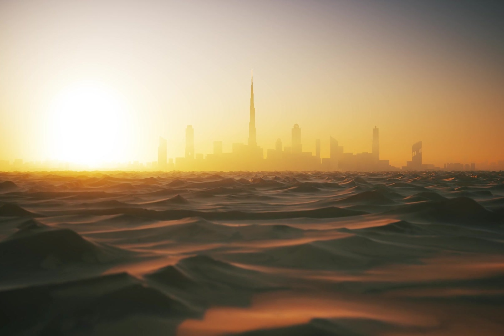 Dubai skyline beyond the desert dunes at sunset